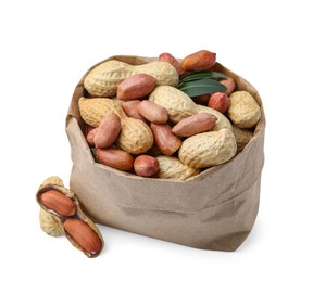 Photo of Fresh peanuts in paper bag and green leaves isolated on white