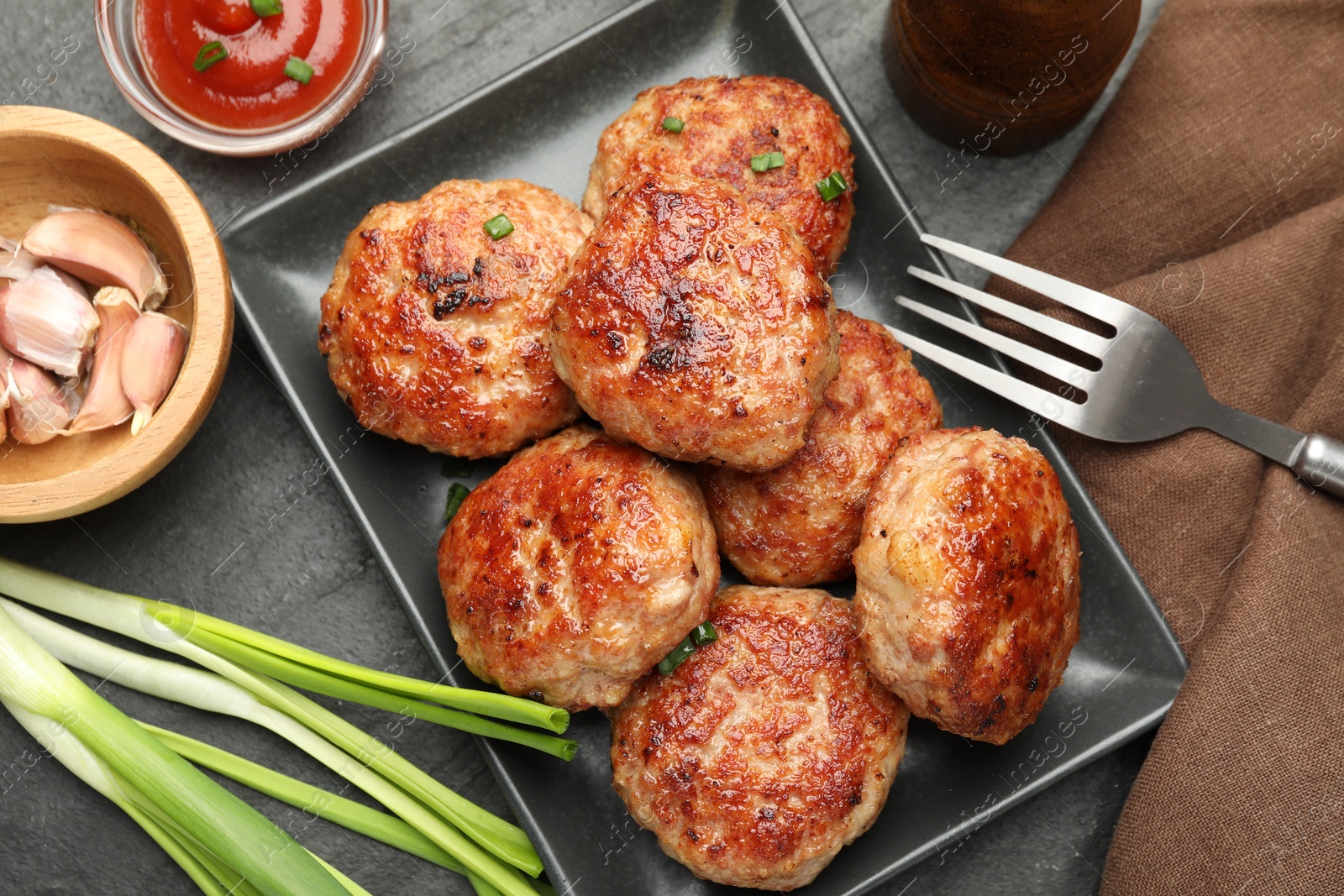 Photo of Delicious patties served on black table, flat lay