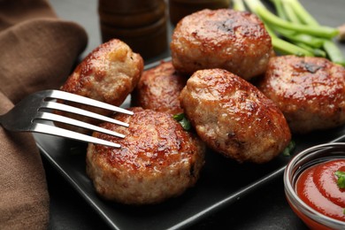 Photo of Delicious patties served on black table, closeup