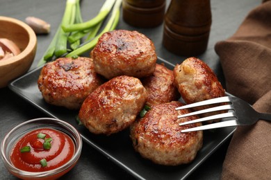 Photo of Delicious patties served on black table, closeup