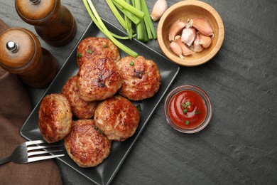 Photo of Delicious patties served on black table, flat lay