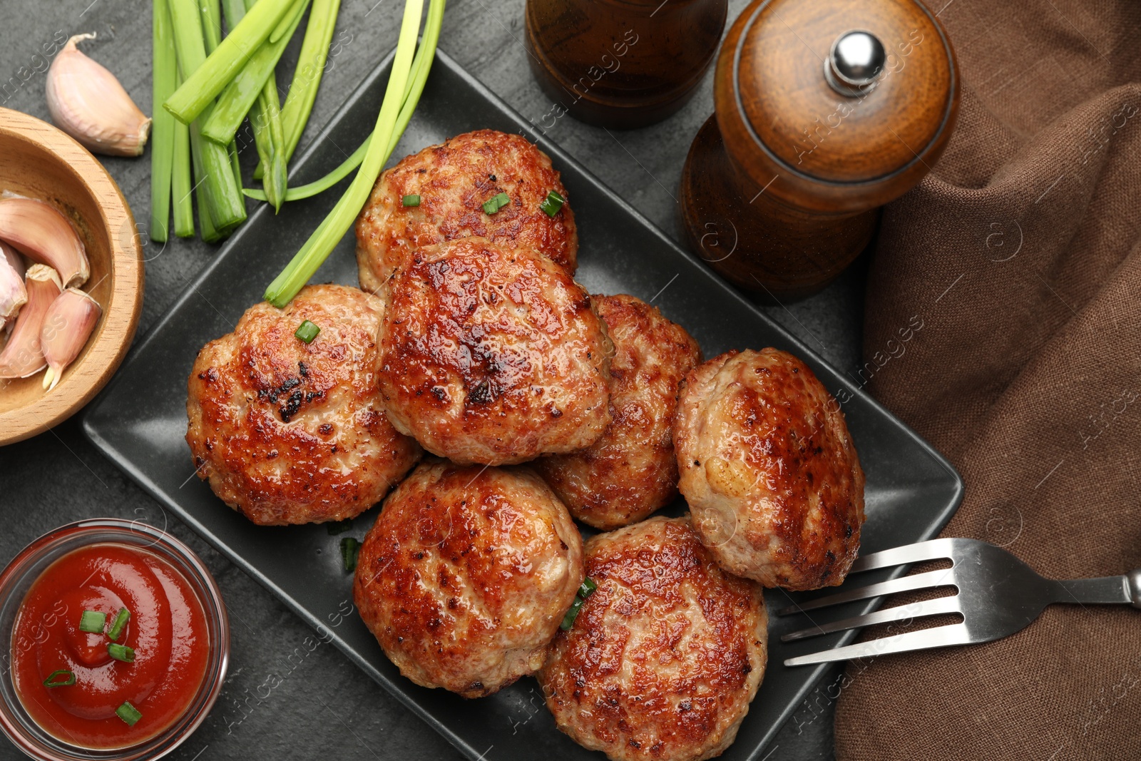 Photo of Delicious patties served on black table, flat lay