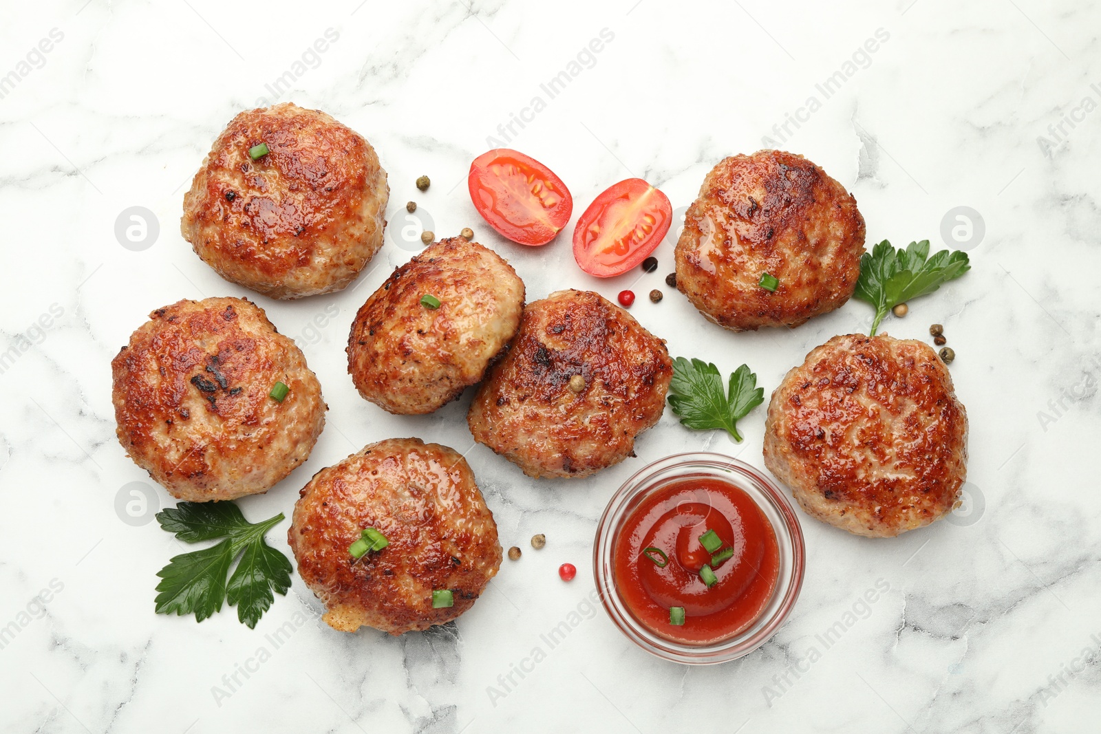 Photo of Delicious patties with sauce, cherry tomatoes, peppercorns and parsley on white marble table, flat lay