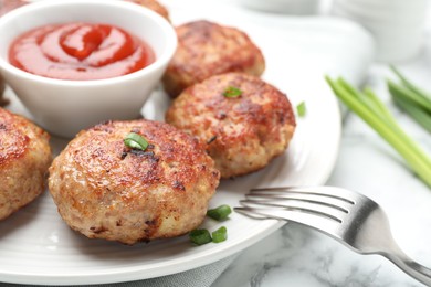 Photo of Delicious patties served on white marble table, closeup