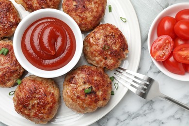 Photo of Delicious patties served on white marble table, flat lay