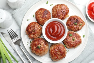 Photo of Delicious patties served on white marble table, flat lay