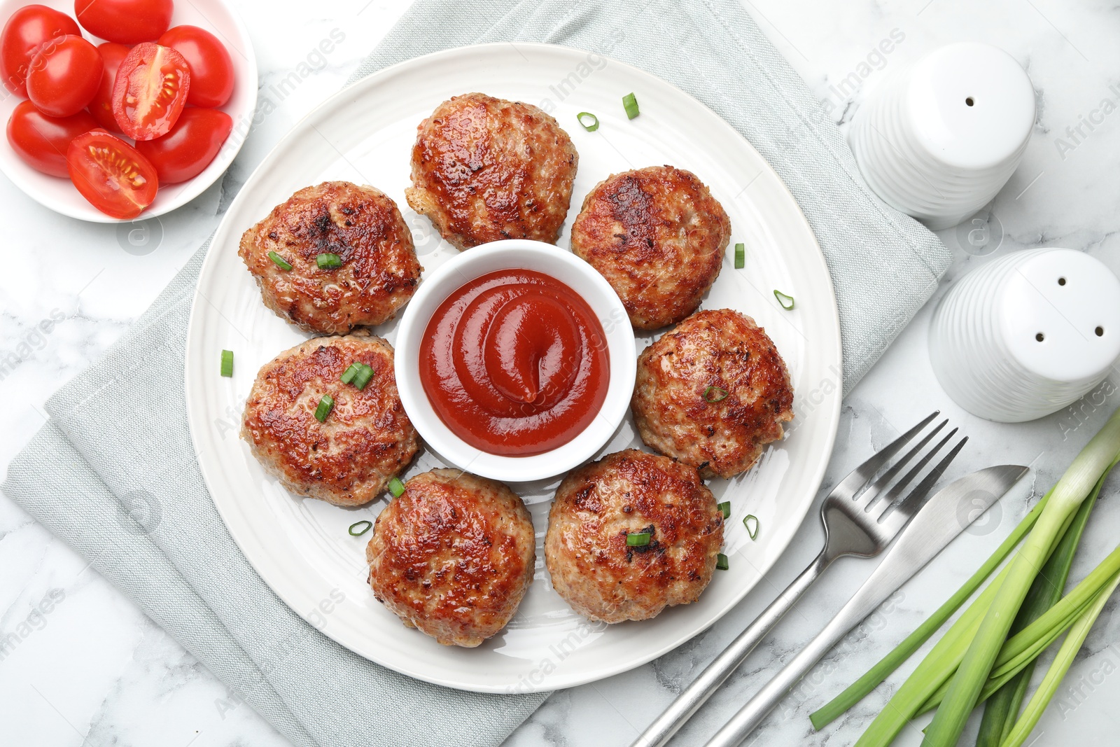 Photo of Delicious patties served on white marble table, flat lay