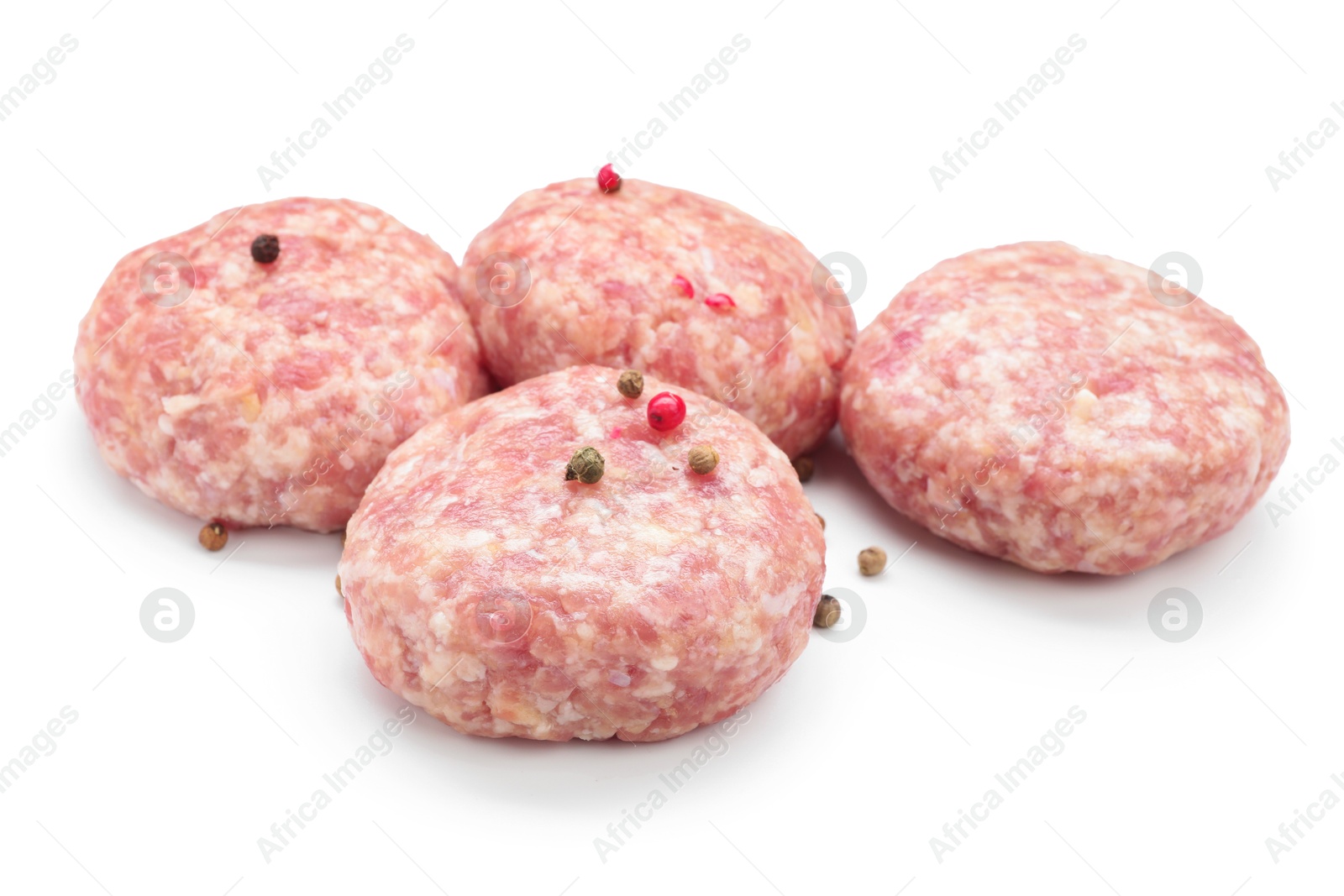 Photo of Many uncooked patties and spices isolated on white