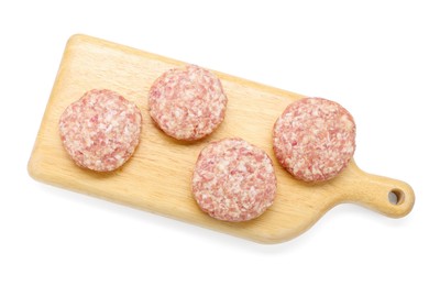 Photo of Many uncooked patties on wooden board against white background, top view