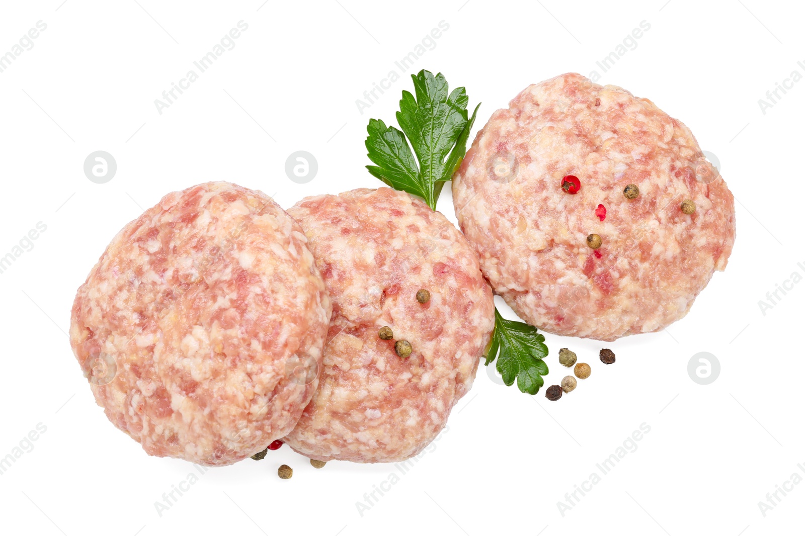 Photo of Three uncooked patties and spices isolated on white, top view