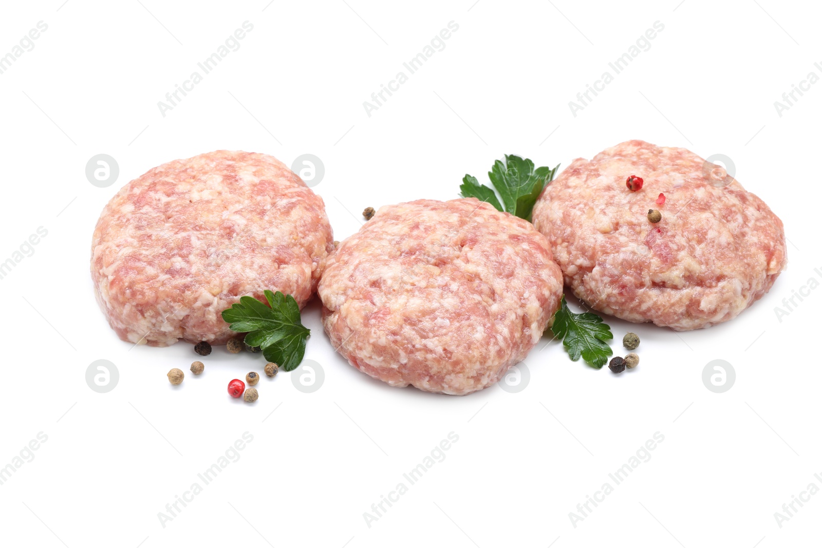 Photo of Three uncooked patties and spices isolated on white