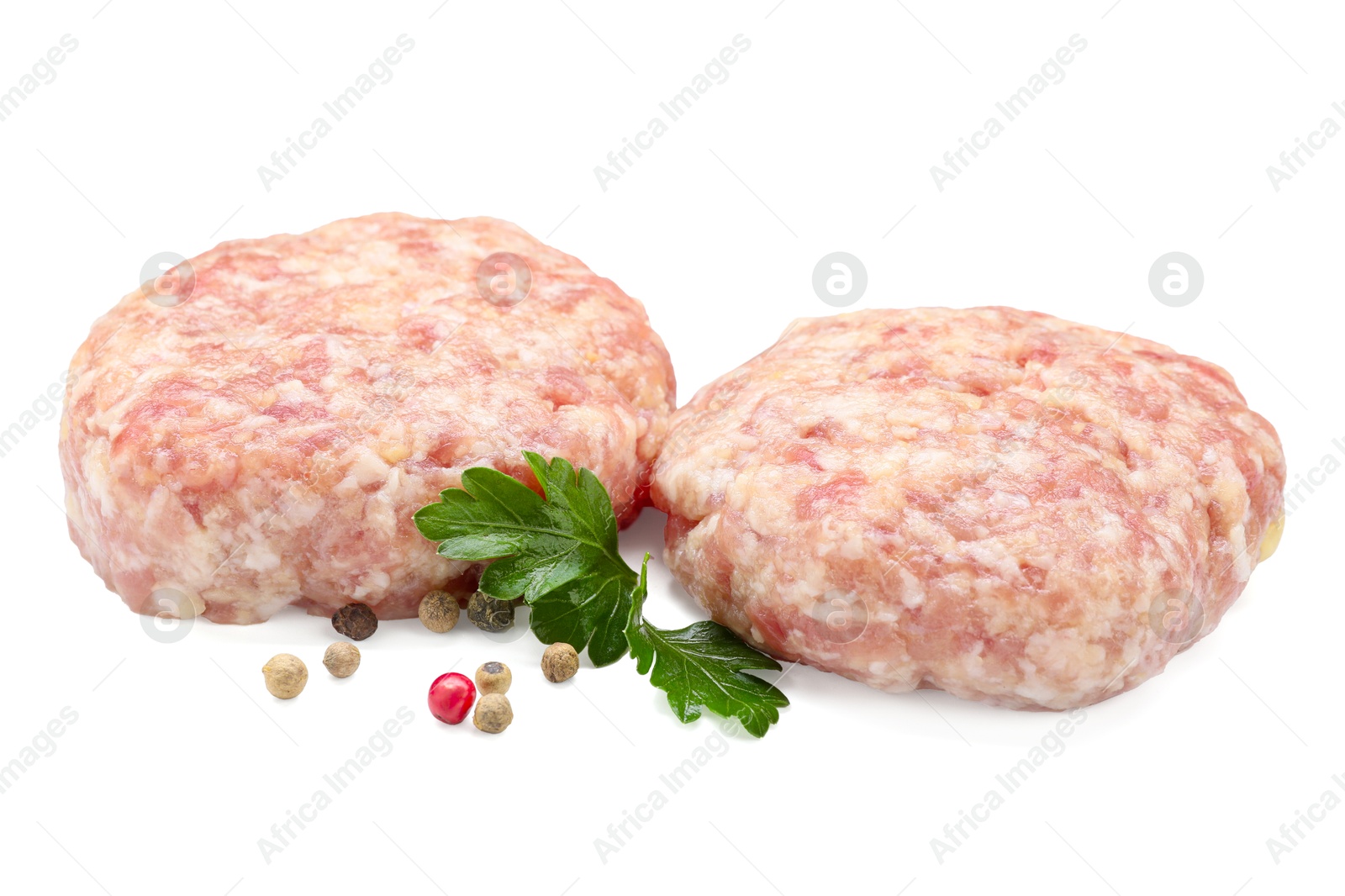 Photo of Two uncooked patties and spices isolated on white