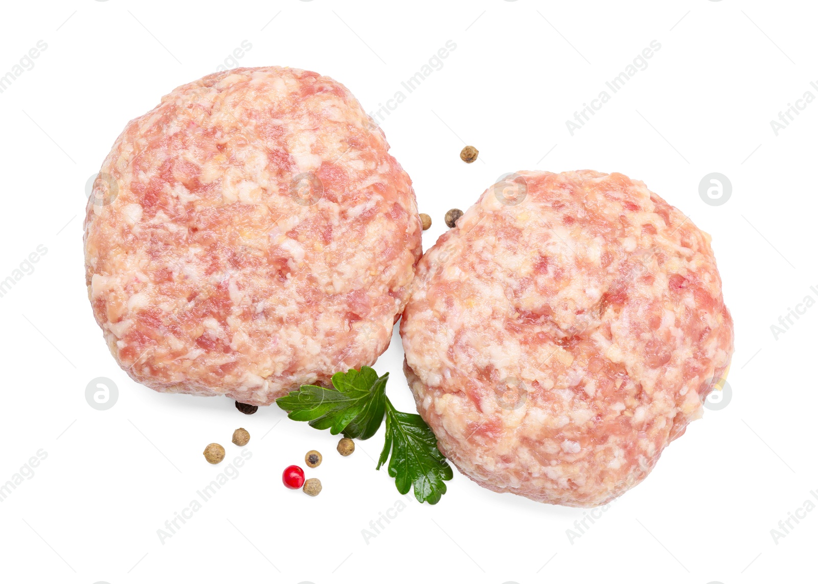 Photo of Two uncooked patties and spices isolated on white, top view