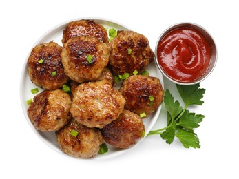 Photo of Delicious patties with green onions, parsley and ketchup isolated on white, top view