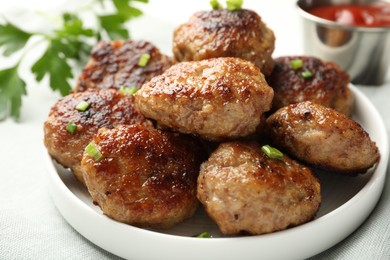 Photo of Delicious patties with green onions on table, closeup