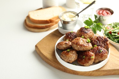 Photo of Delicious patties served on white table, closeup. Space for text