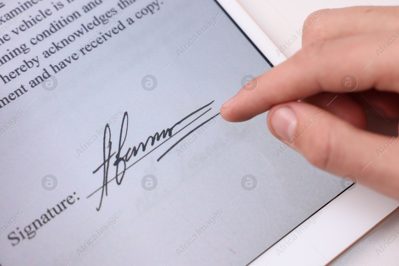 Photo of Electronic signature. Man using tablet at table, closeup