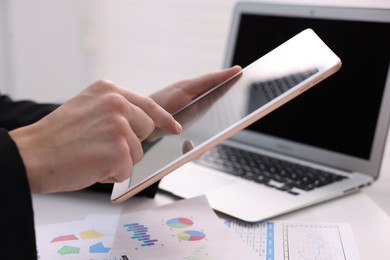 Photo of Electronic signature. Man using tablet at table, closeup