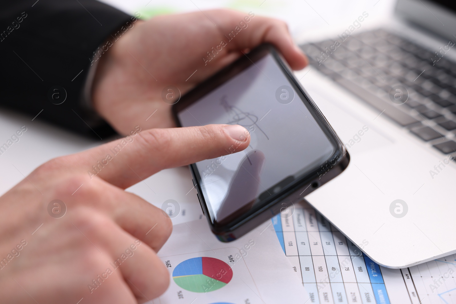 Photo of Electronic signature. Man using smartphone at table, closeup