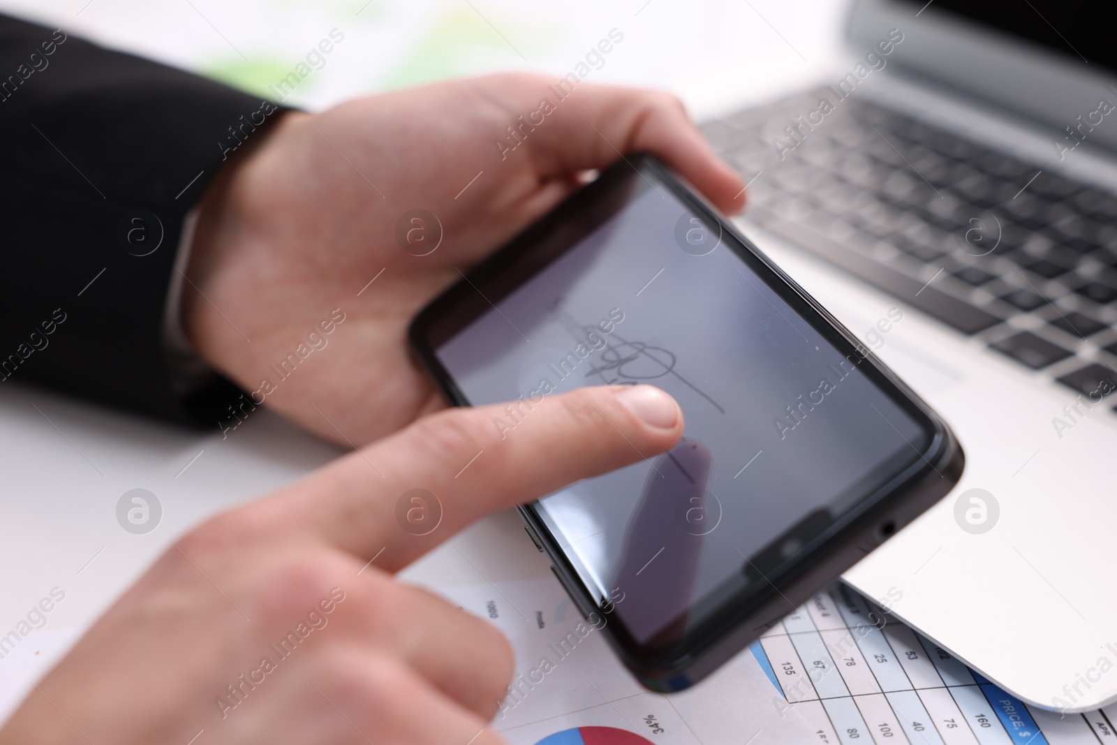 Photo of Electronic signature. Man using smartphone at table, closeup