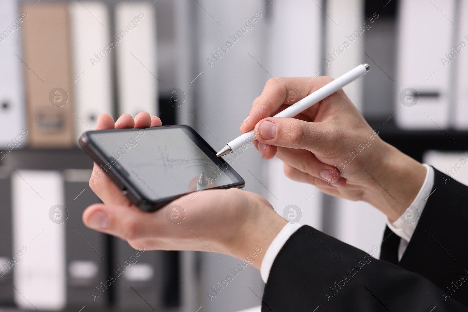 Photo of Electronic signature. Man using stylus and smartphone indoors, closeup