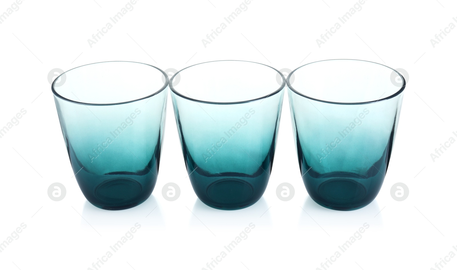 Photo of Three empty clean glasses isolated on white