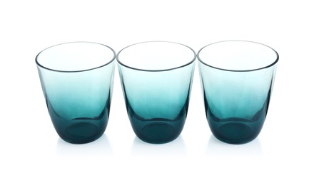 Photo of Three empty clean glasses isolated on white