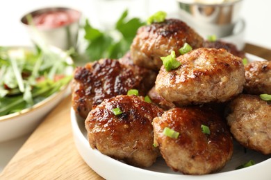 Photo of Delicious patties with green onions on table, closeup