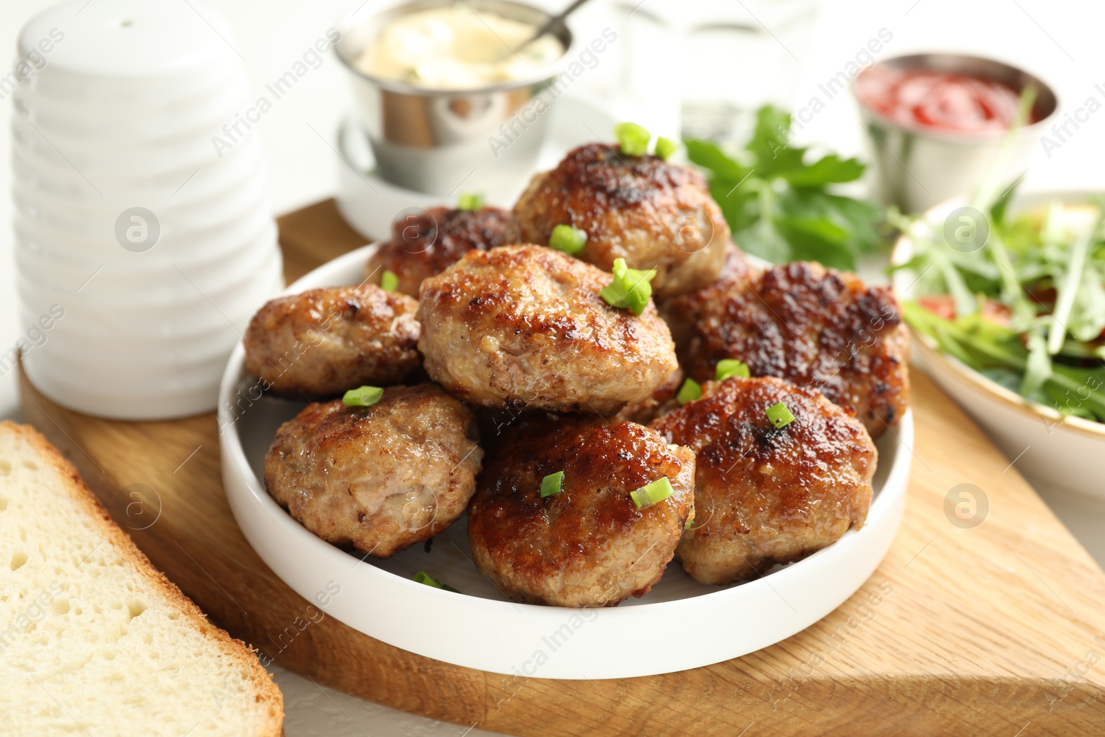 Photo of Delicious patties with green served on table, closeup