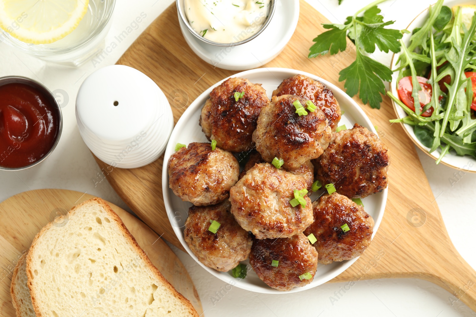 Photo of Delicious patties with green served on white table, flat lay