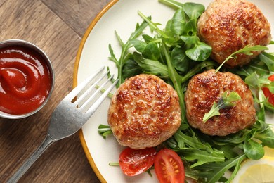 Photo of Delicious patties with greens, tomato and ketchup on wooden table, flat lay