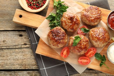 Photo of Delicious patties served on wooden table, flat lay. Space for text