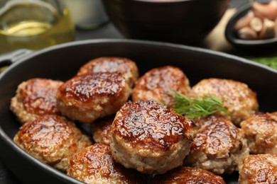 Photo of Delicious patties in baking dish on table, closeup