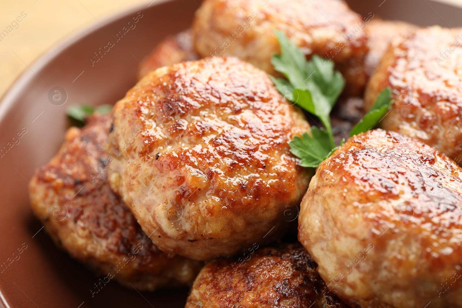 Photo of Delicious patties with parsley on plate, closeup