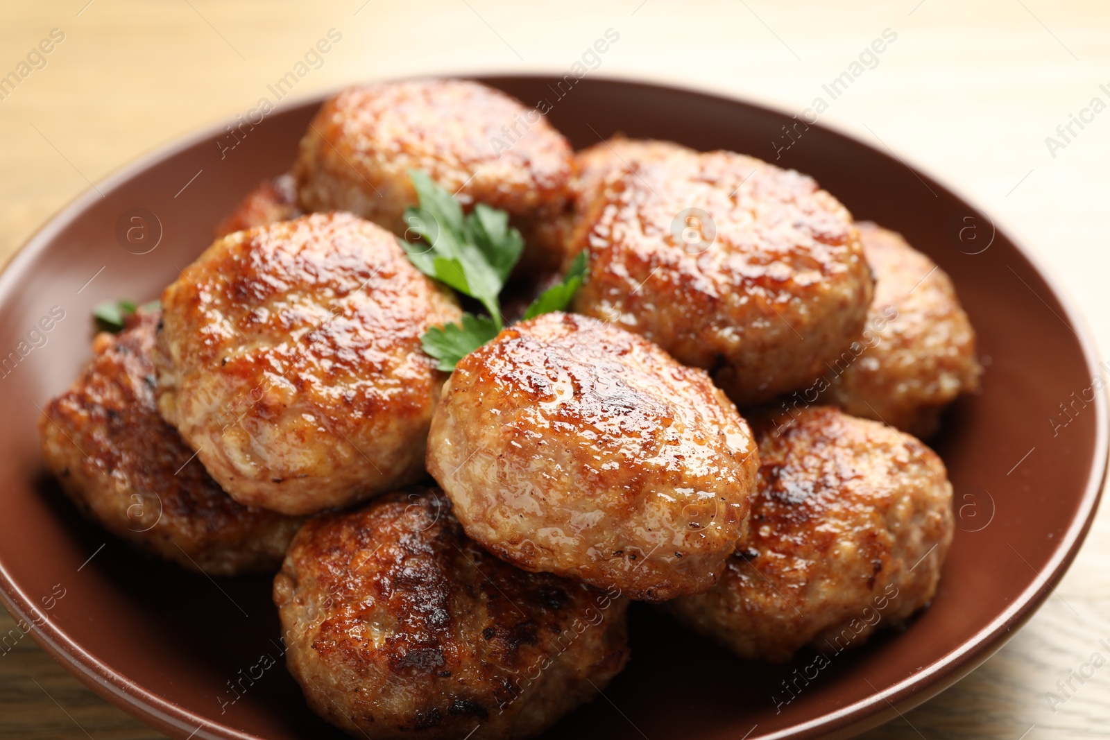 Photo of Delicious patties with parsley on table, closeup