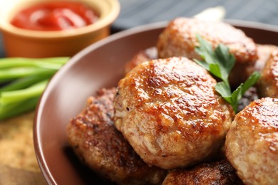 Photo of Delicious patties with parsley on table, closeup