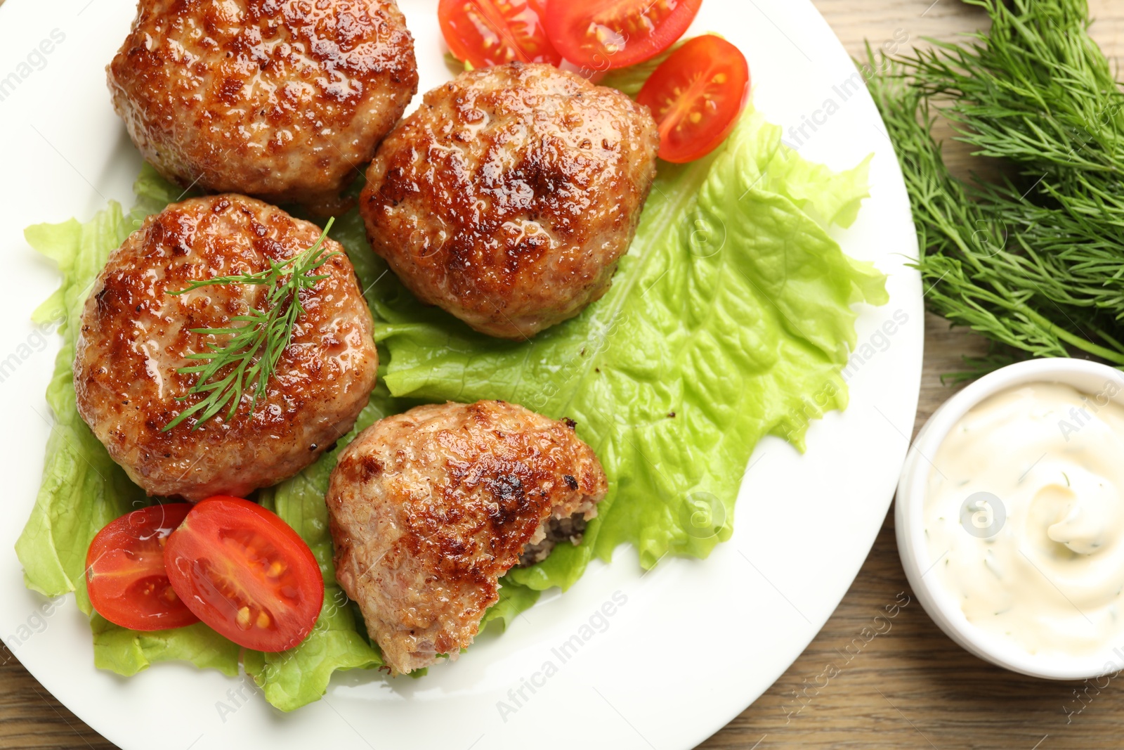 Photo of Delicious patties served on wooden table, flat lay