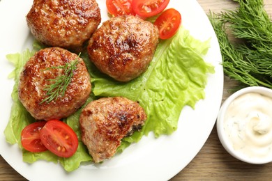 Photo of Delicious patties served on wooden table, flat lay