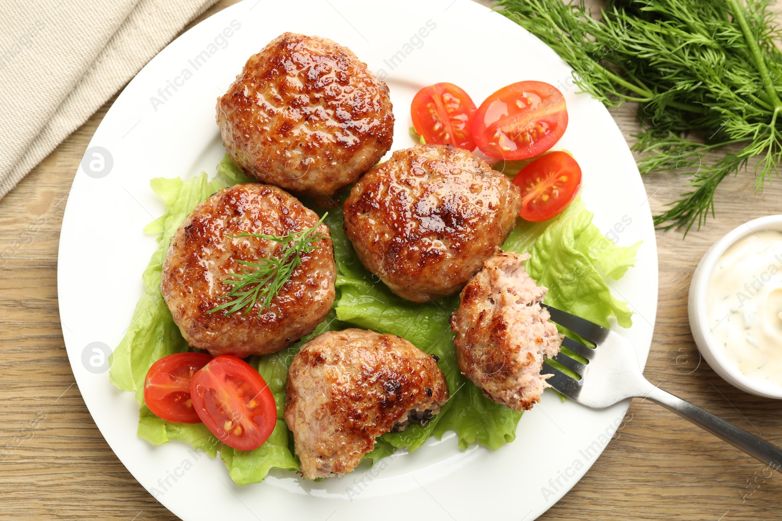 Photo of Delicious patties served on wooden table, flat lay