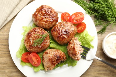 Photo of Delicious patties served on wooden table, flat lay