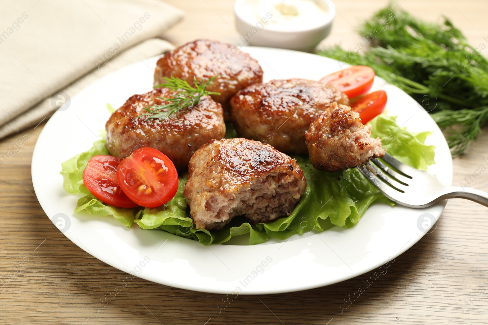 Photo of Delicious patties served on wooden table, closeup