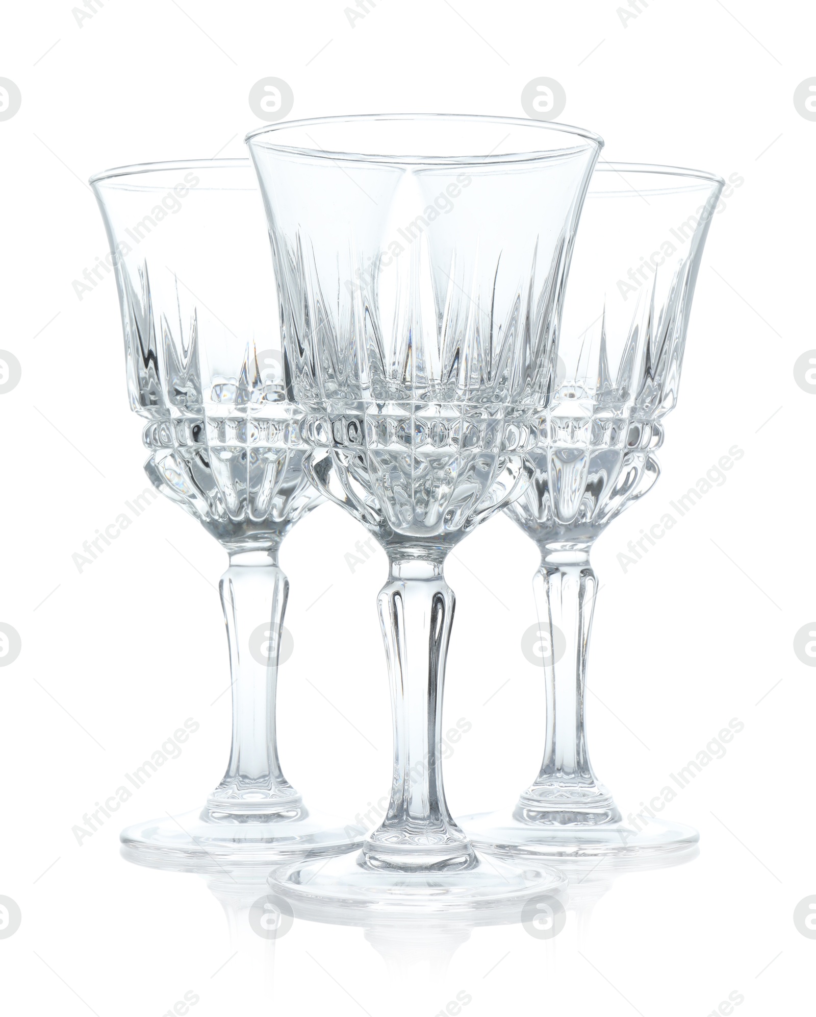 Photo of Three empty clean glasses isolated on white