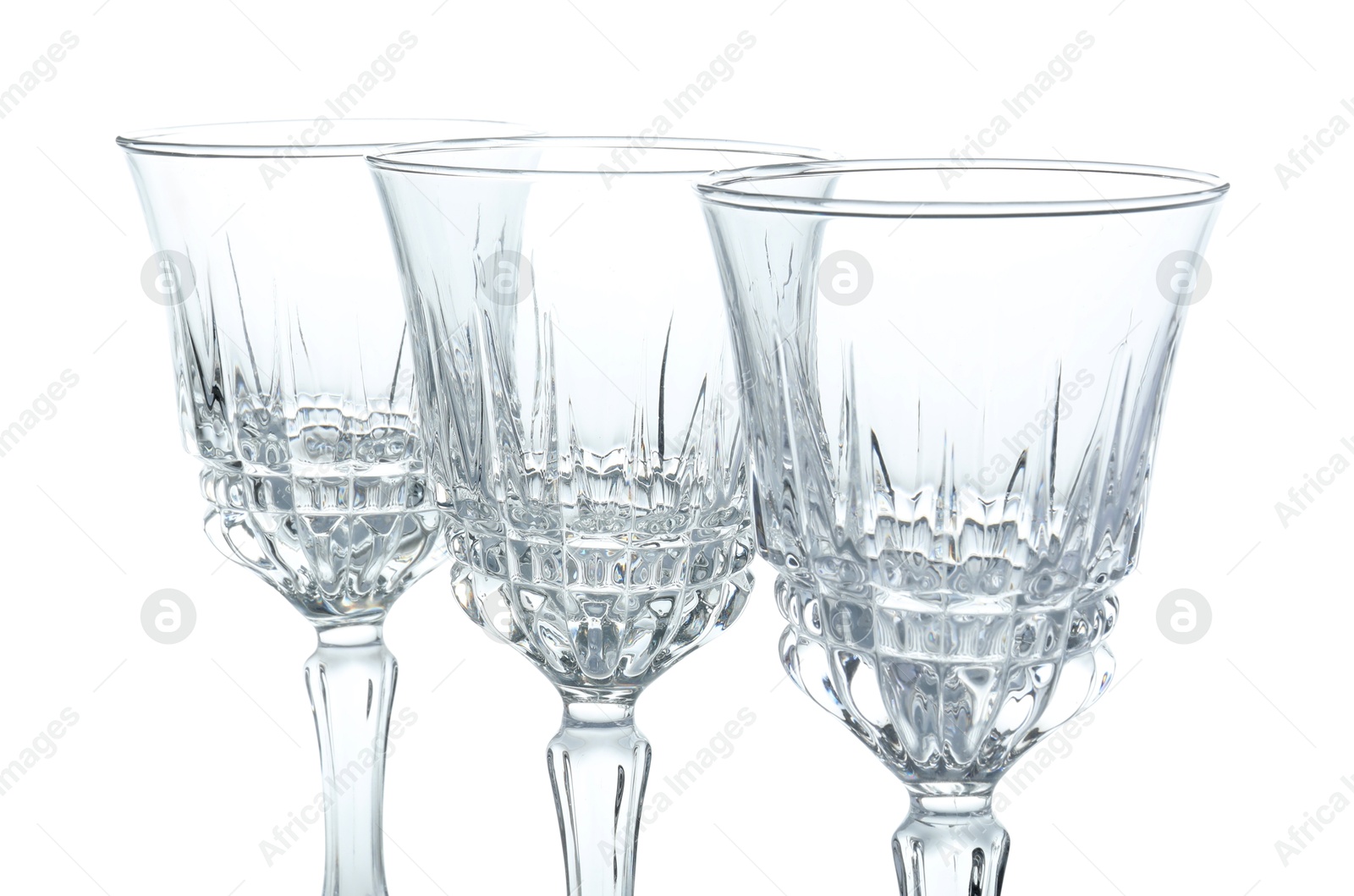 Photo of Three empty clean glasses isolated on white