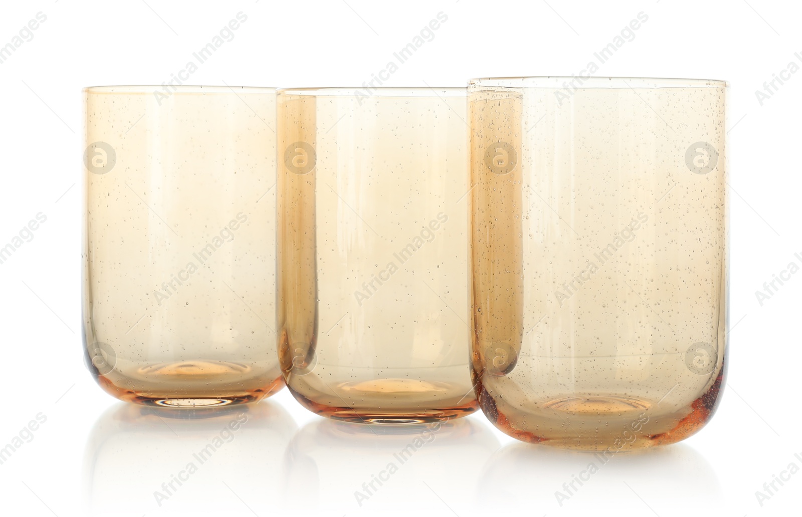 Photo of Three empty clean glasses isolated on white