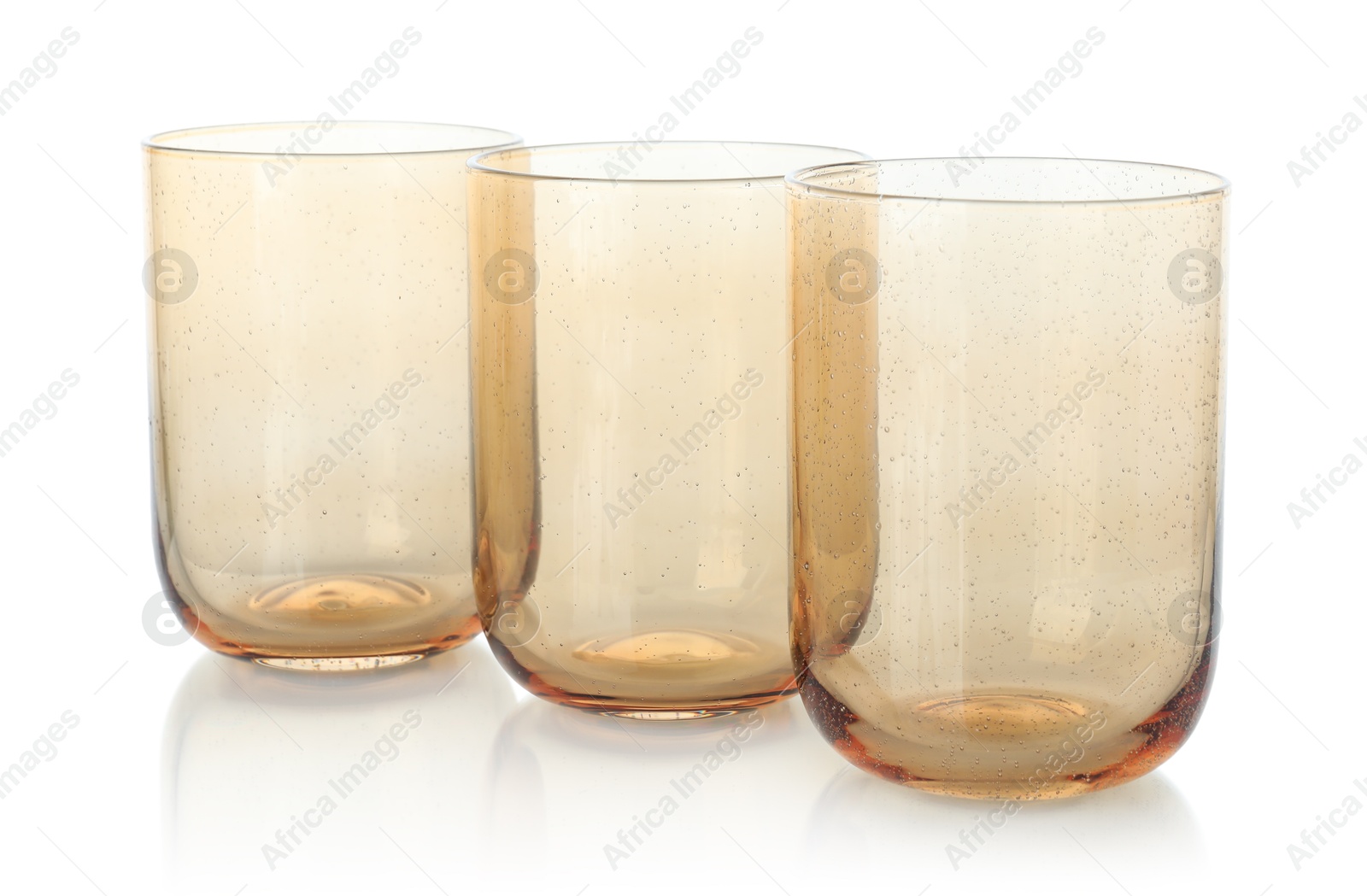 Photo of Three empty clean glasses isolated on white