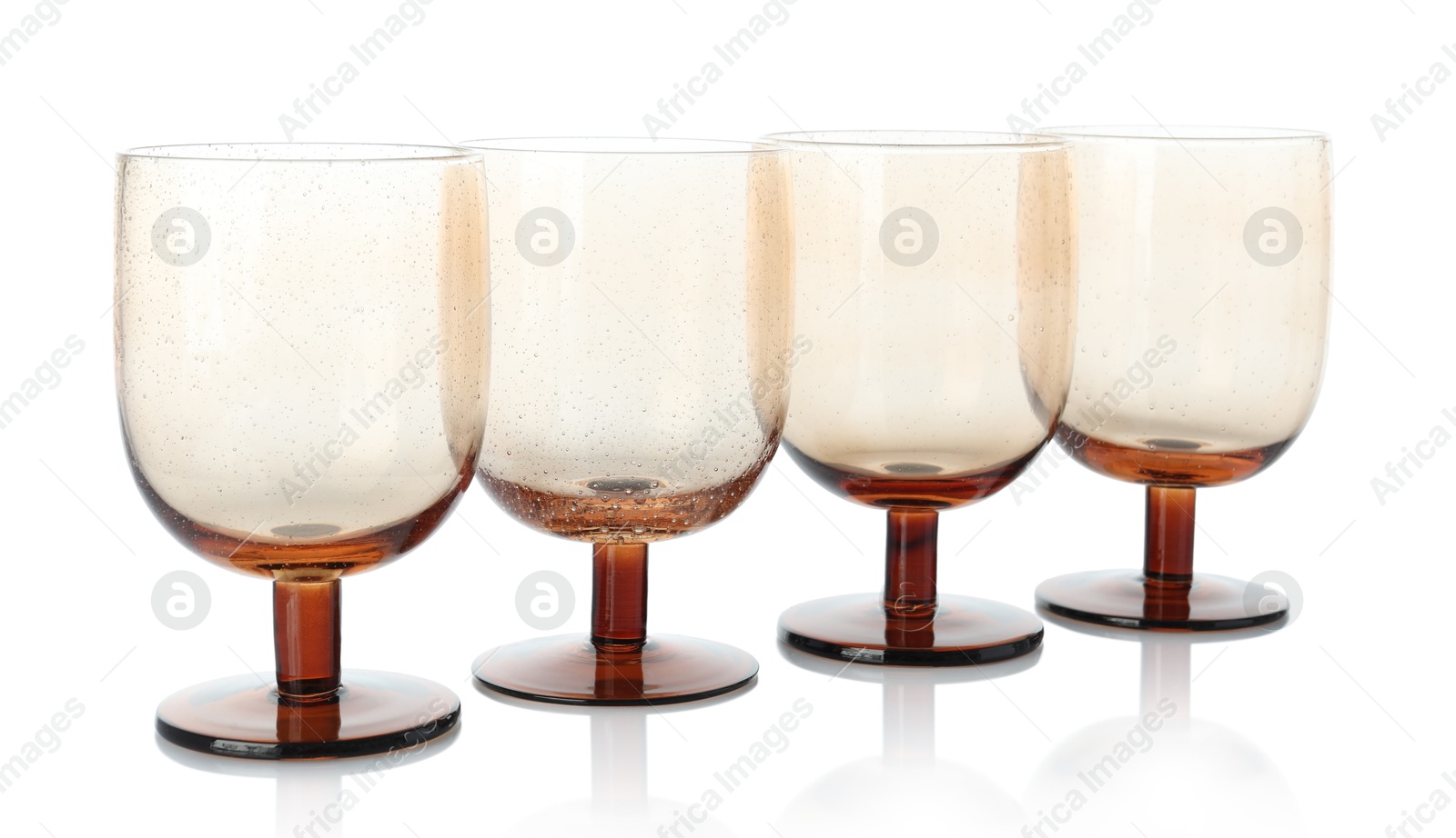 Photo of Many empty clean glasses isolated on white