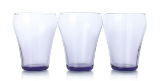 Photo of Three empty clean glasses isolated on white