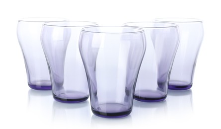 Photo of Many empty clean glasses isolated on white