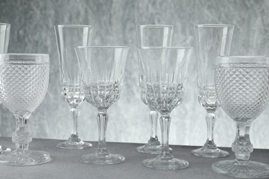 Photo of Many empty clean glasses on grey table