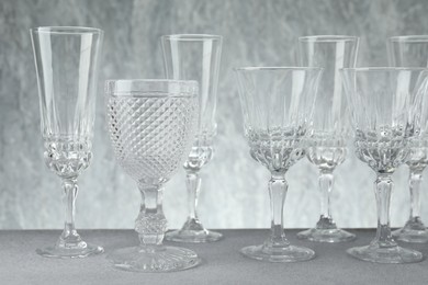 Photo of Many empty clean glasses on grey table